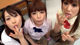 Three sweet Japanese school girls suck on one throbbing cock and eat cum